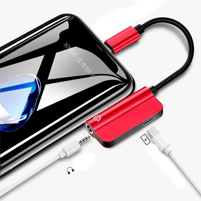 Un teléfono celular se está cargando con un cargador rojo y negro