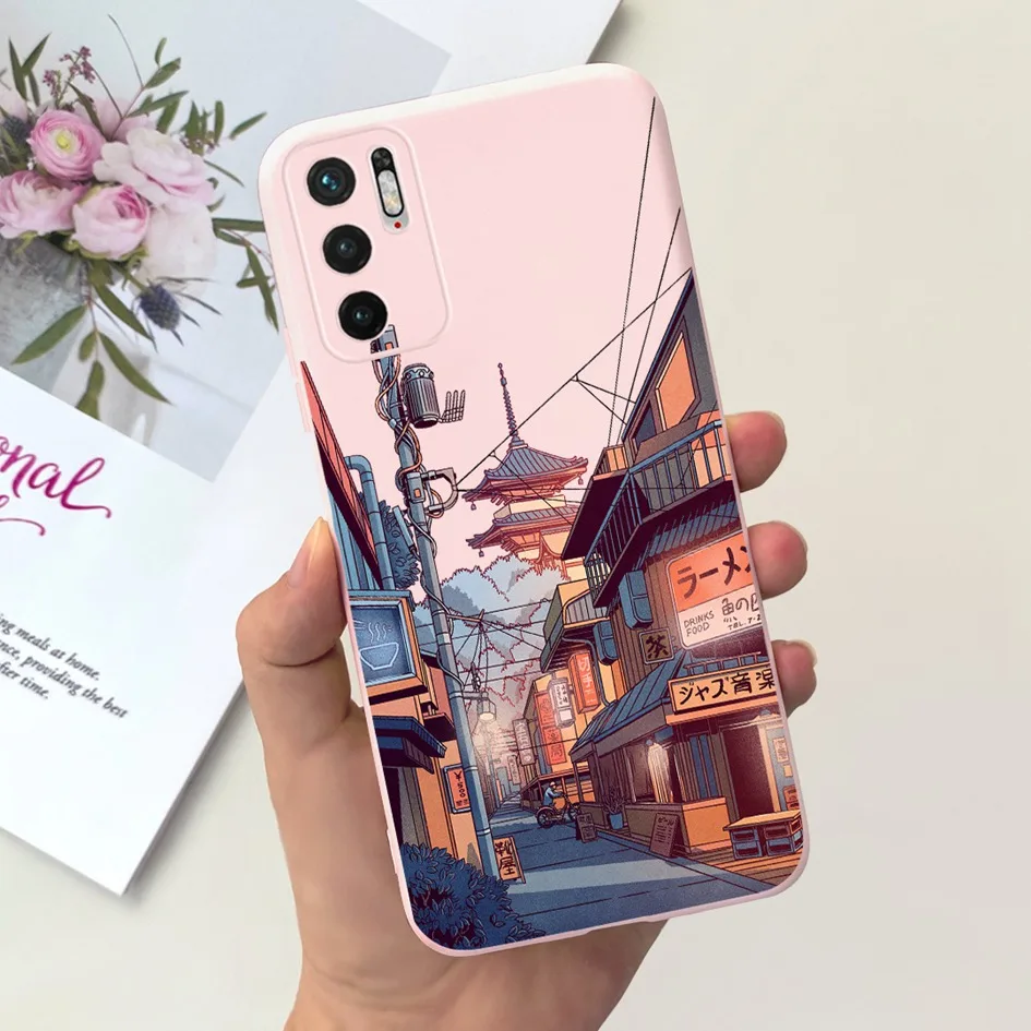 un teléfono celular rosa con una foto de una ciudad en él