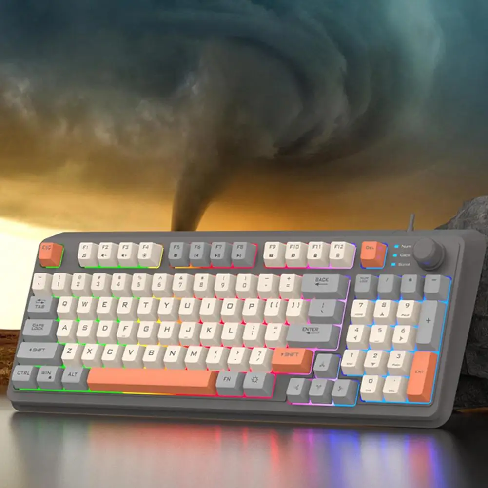 Un teclado con un diseño colorido y un cielo tormentoso en el fondo