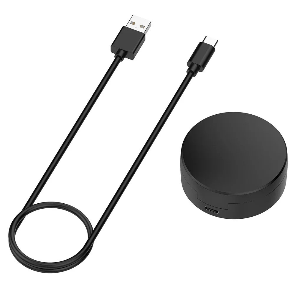 Un dispositivo negro con cable negro y un círculo negro en la parte superior