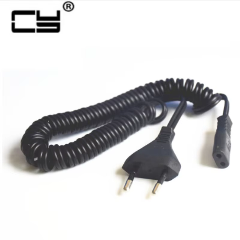 Cable UXG enrollado junto a una afeitadora Braun